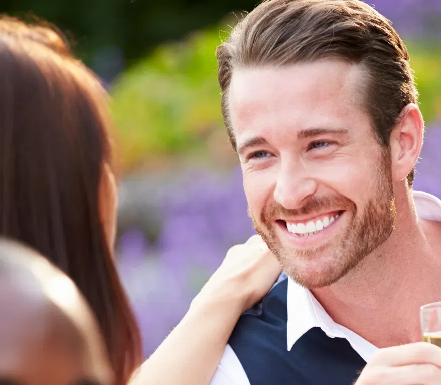 DEIGHT guest smiling during a relaxed outdoor social mixer